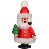 A carved wooden Santa Claus with a pipe, accompanied by a decorative tree, representing a classic holiday decoration.